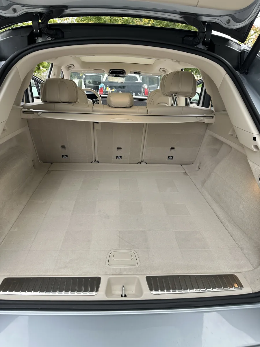 After: the same cargo area, empty, with clean carpet