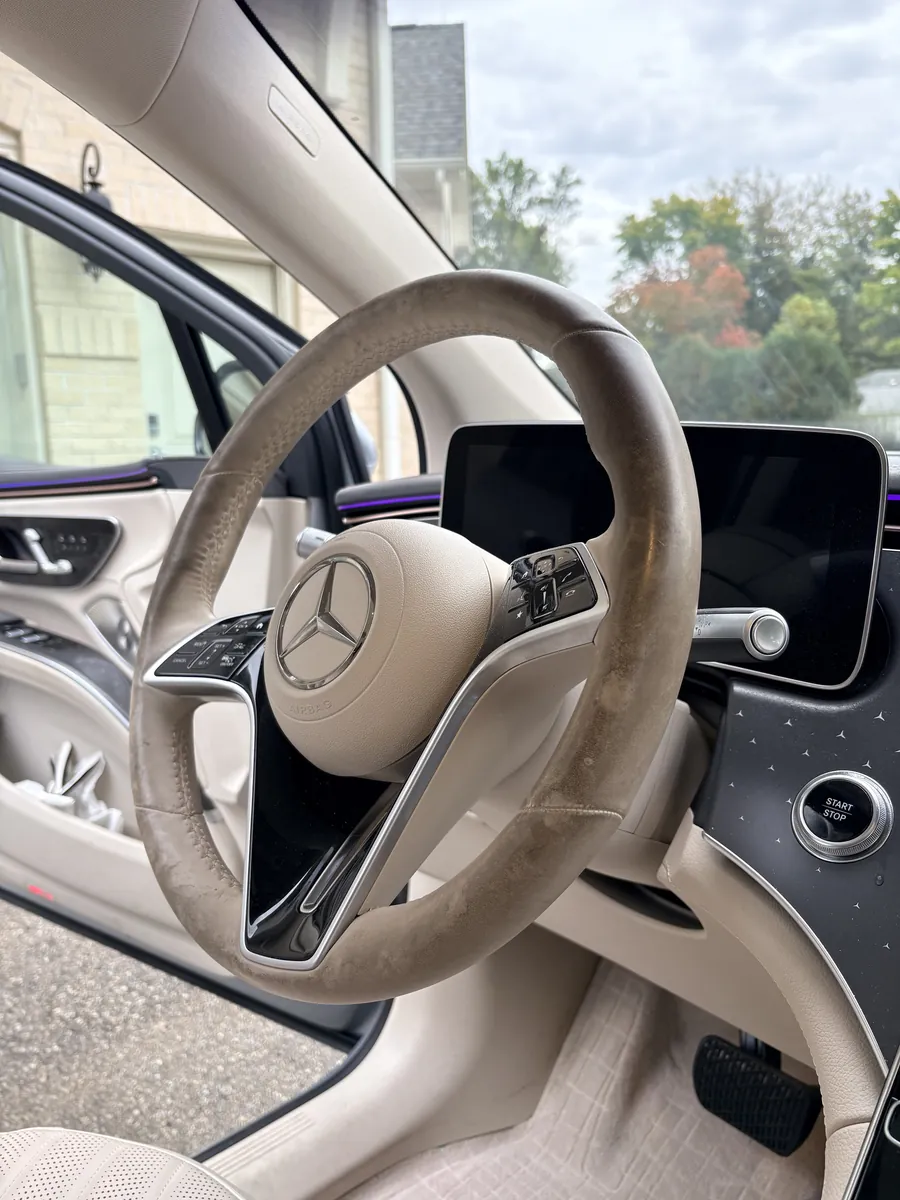 Before: a cream steering wheel with a grimy, darkened rim